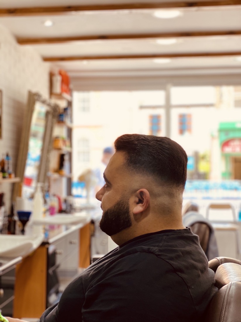 A finished skin fade with a sharp beard line-up at Cutt Throat